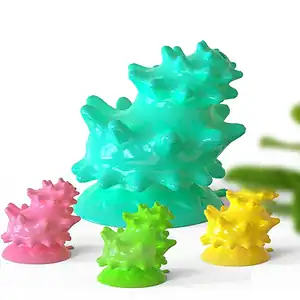 Colorful spiky silicone molds in green, pink, light green, and yellow on a white background.