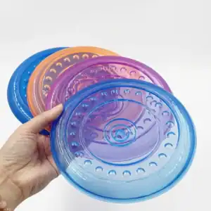 A hand holds three translucent frisbees in blue, purple, and orange, each with circular ridged patterns.