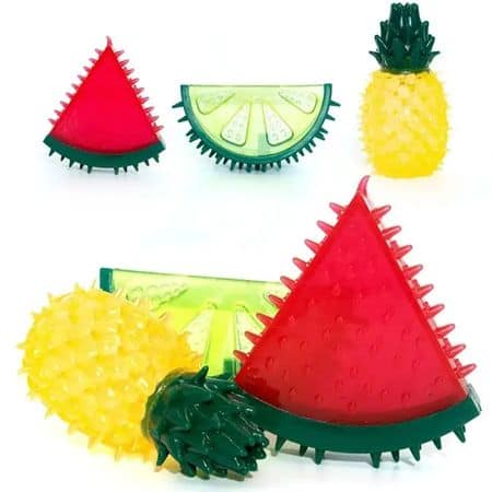 Three textured dog chew toys—a watermelon slice, lime wedge, and pineapple—shown on a white background.