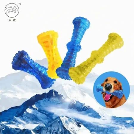 Four blue and yellow rubber dog chew toys over a snowy mountain, with an inset of a dog holding one toy in its mouth.