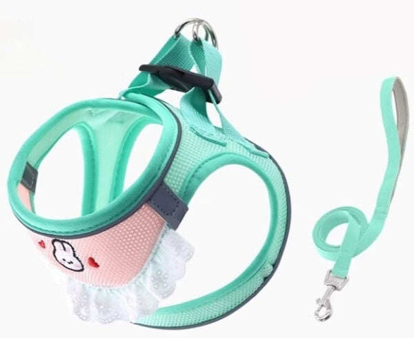 Light blue kitten harness with pink cartoon face, lace trim, and matching leash with metal clasp.