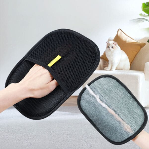 Hand wearing pet hair remover glove with fur stuck to it; a white cat sits on a couch in the background.