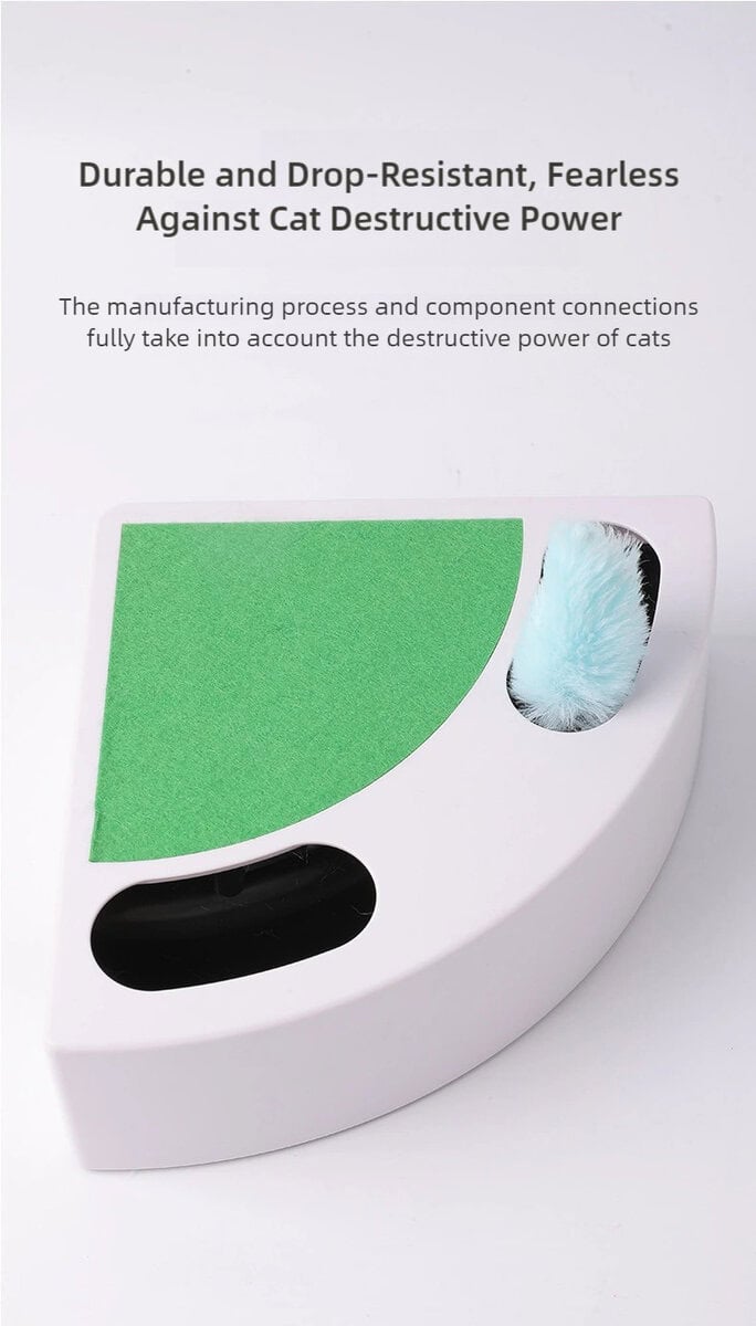 White quarter-circle cat toy with green textured surface, blue fluffy ball, black compartment, and durability text.