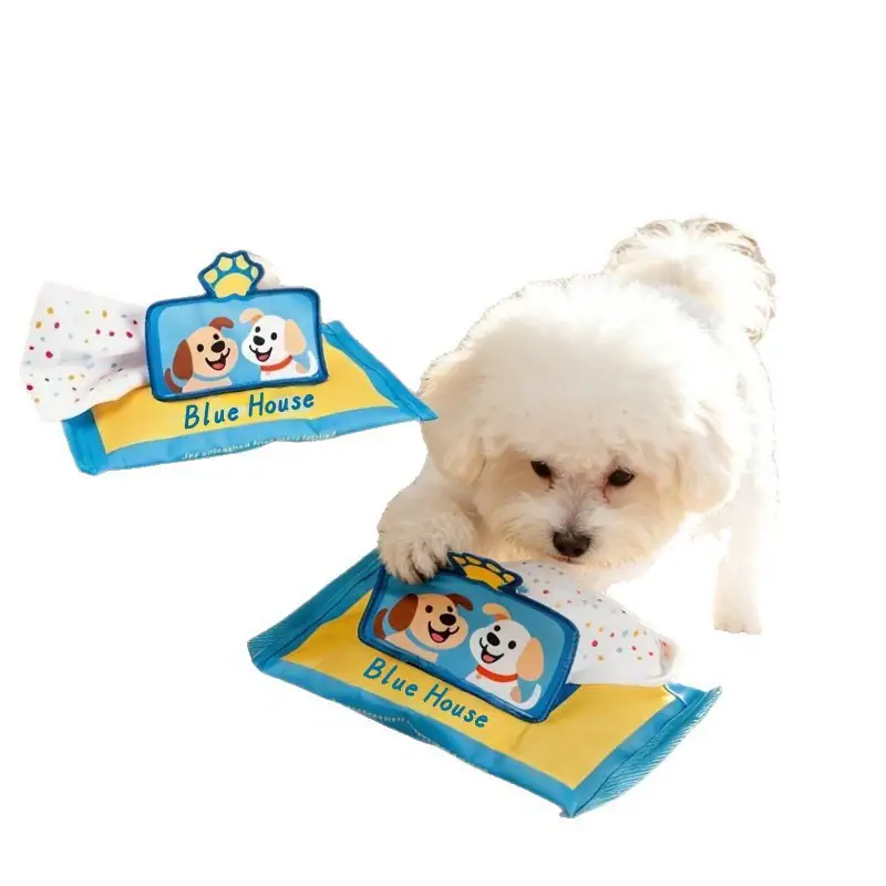 Adorable white puppy playing with Blue House branded pet wipes, emphasizing pet care and hygiene products.