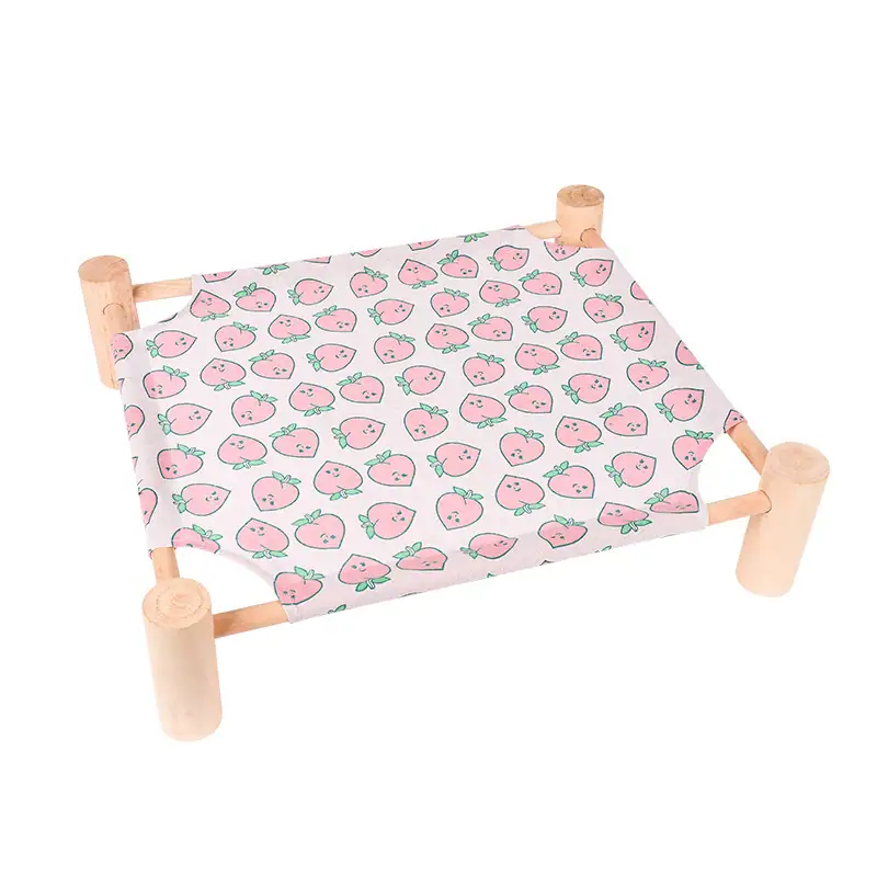 Small cat bed with a pink strawberry pattern on fabric, supported by four wooden legs, designed for pet comfort and style.