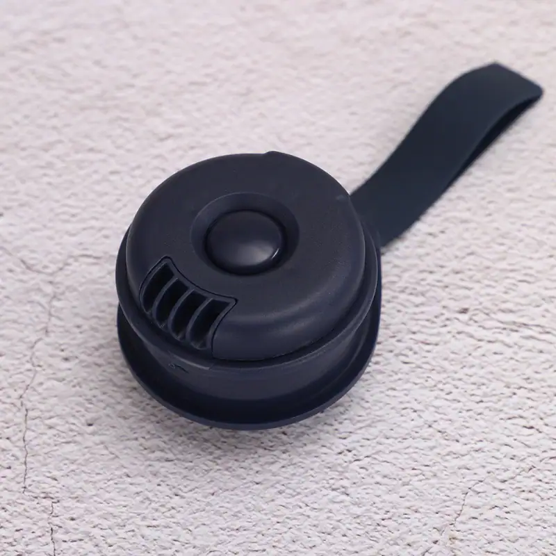 Compact black portable Bluetooth speaker with a rounded design and a strap for easy carrying, ideal for outdoor and indoor use.