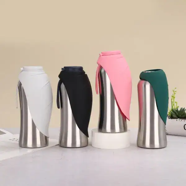 Set of four stainless steel travel mugs with colorful silicone sleeves in white, black, pink, and green, on a light background.