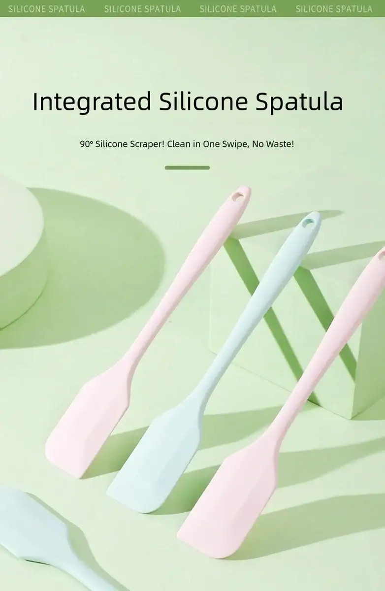 Set of three pastel-colored silicone spatulas in pink, blue, and white, displayed on a light green background with a modern design.