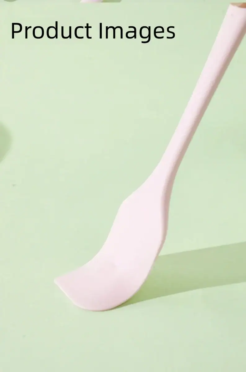 White kitchen spoon with a long handle on a pastel green background, ideal for cooking and serving.
