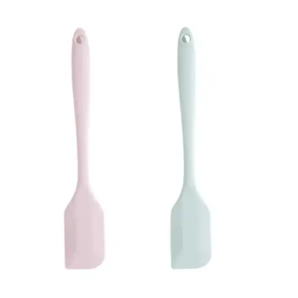 Set of two silicone spatulas in pastel pink and pastel blue, ideal for cooking and baking, with ergonomic handles and heat-resistant design.